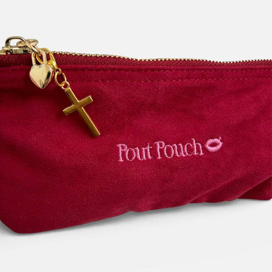 Cross charm clipped onto Pout Pouch zipper