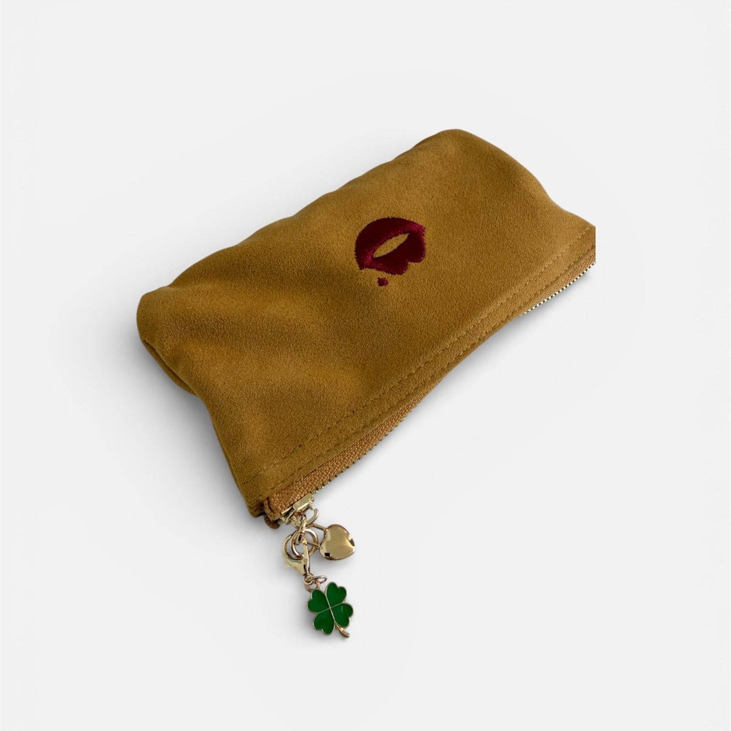 Four leaf clover charm clipped onto Pout Pouch