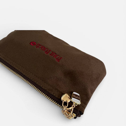 Coffee charm clipped onto brown Pout Pouch zipper