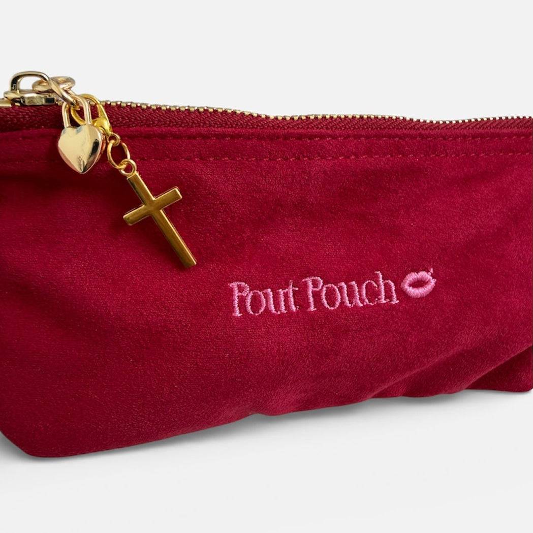 Cross charm clipped onto Pout Pouch zipper
