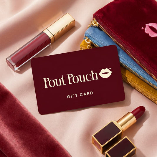 Pout Pouch gift card displayed with velvet makeup pouches and lipstick on a soft satin background