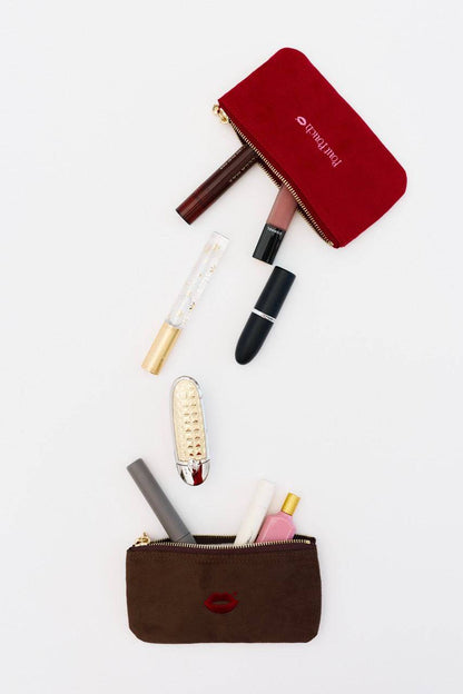 Makeup essentials dropping into Pout Pouch velvet makeup pouch