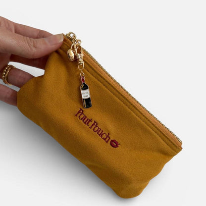 Wine charm accessory attached to Pout Pouch zipper